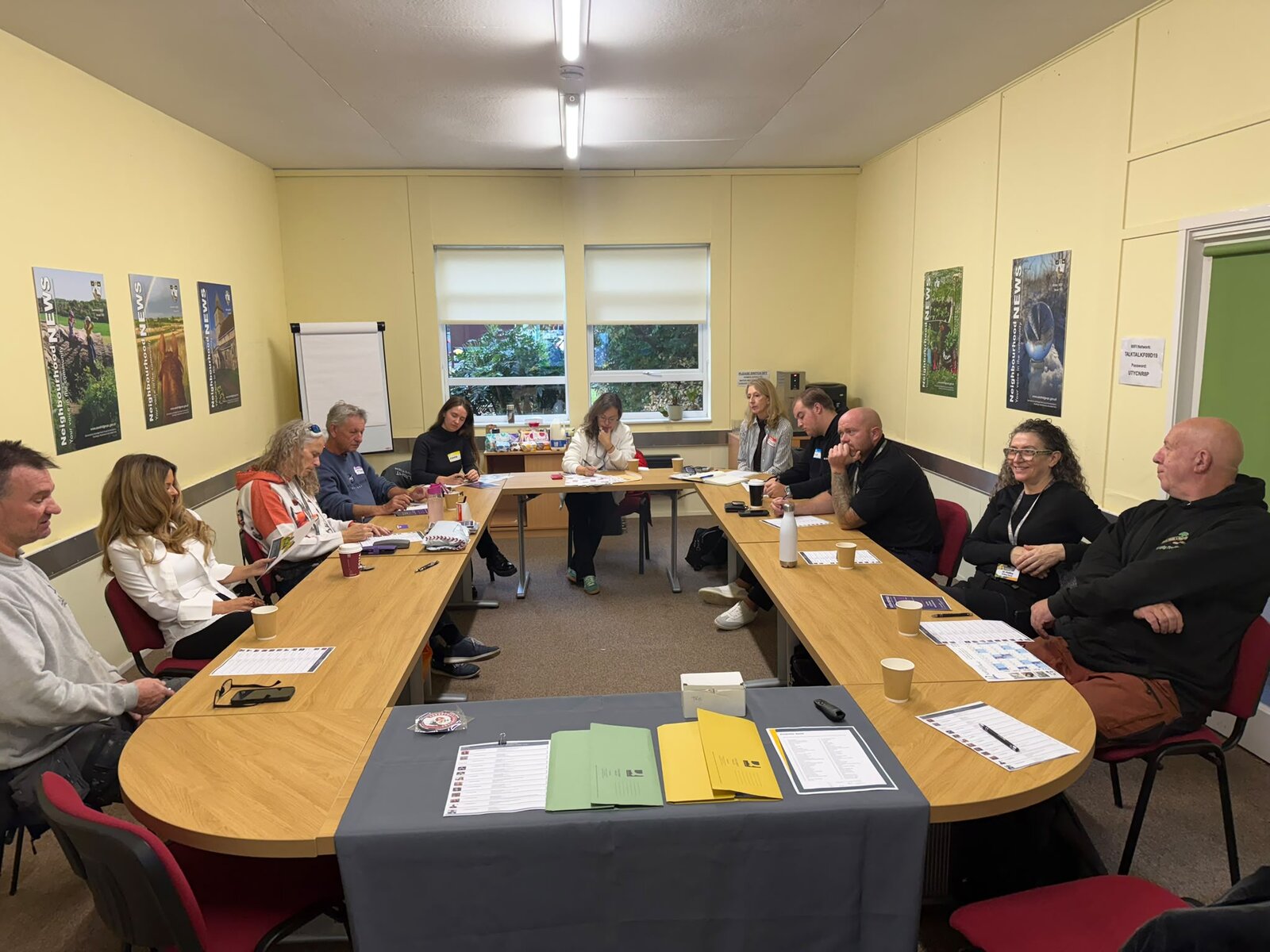 The Grafters St Albans group round the table before the talk
