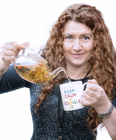 Jo Hailey CEO of Striking Places Photography pouring flower tea from a glass teapot into a 'keep calm and google it' mug